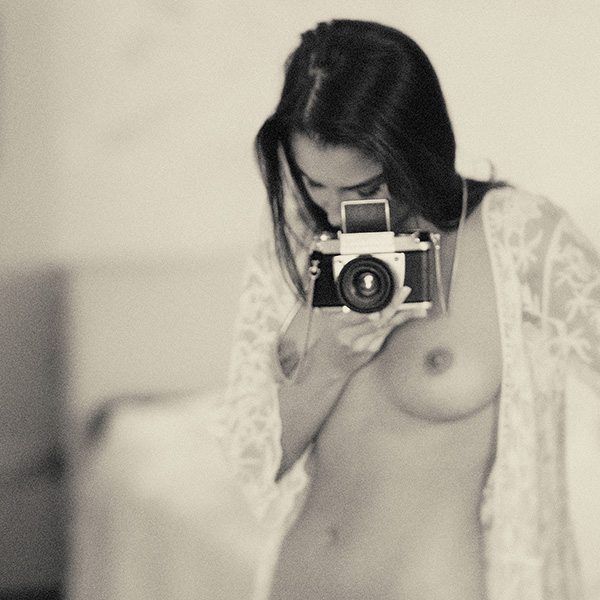 Erotic photography that captures intimacy and secrets by looking into the camera.