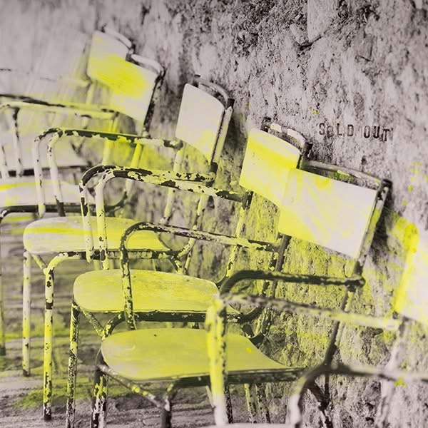 Sold Out – Split Screen one-of-a-kind, six chairs overpainted in yellow against stone wall